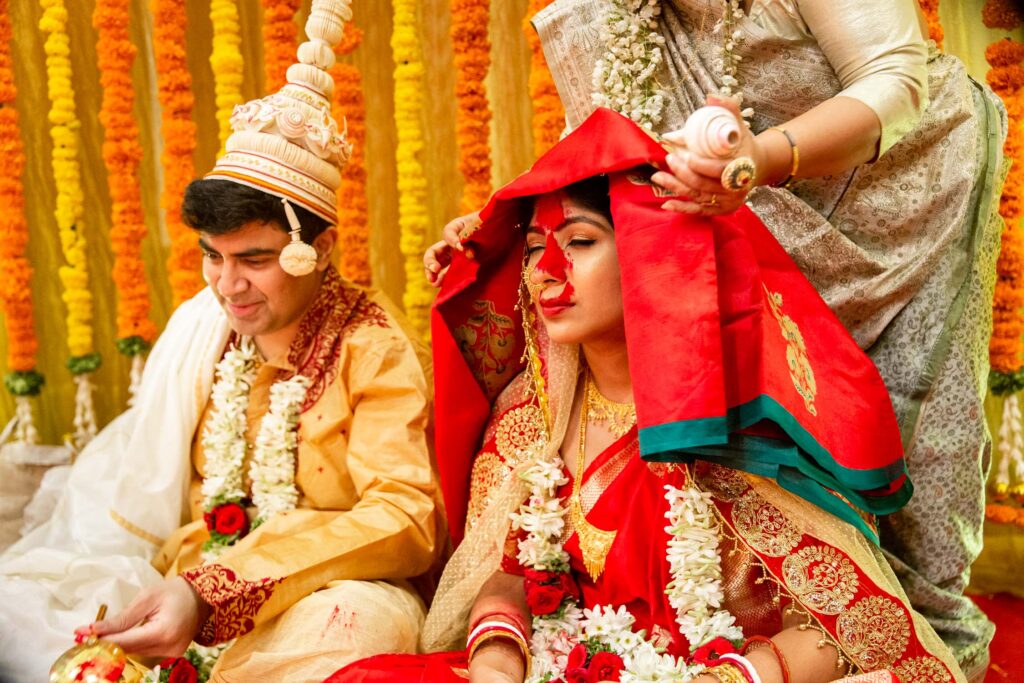 Photo of Bengali bride and groom in bangalore by dropdstudio weddings
